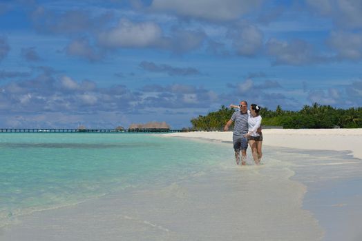 happy young romantic couple in love have fun running and relaxing on beautiful beach