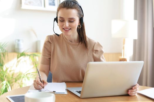 Freelance operator talking with headsets and consulting clients from home office