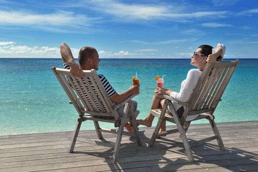 happy young couple relax and take fresh drink at summer vacation