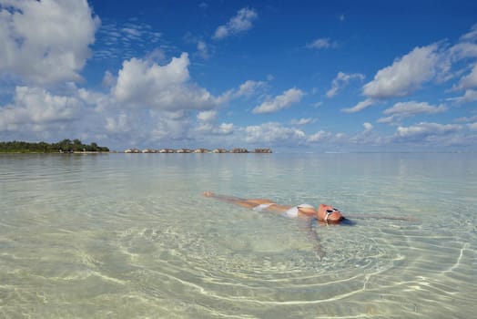 happy young woman on summer vacation on beautiful tropical beach have fun enjoy and relax