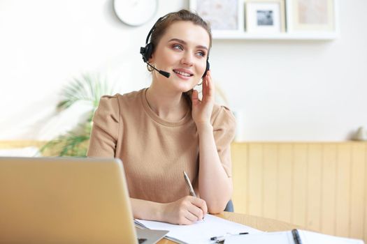 Freelance operator talking with headsets and consulting clients from home office