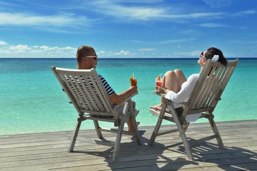 happy young couple relax and take fresh drink at summer vacation