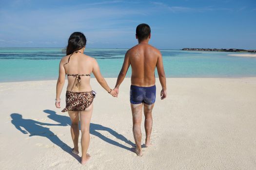 happy young asian couple enjoying summer and have on beautiful white sand beach