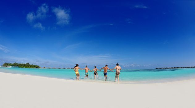 group of happy young people have fun and joy at the  white sand  beach on beautiful summer  day