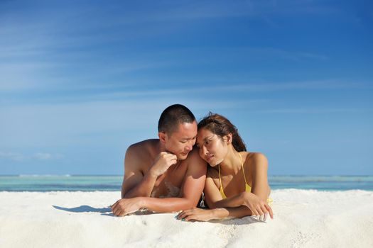 happy young asian couple enjoying summer and have on beautiful white sand beach