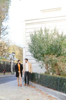 American gays walking and holding hands in city. Concept of same sex couple and lgbt.