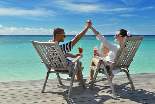 happy young couple relax and take fresh drink at summer vacation