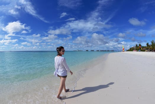 happy young woman on summer vacation on beautiful tropical beach have fun enjoy and relax