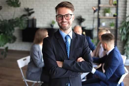 Businessman with colleagues in the background in office