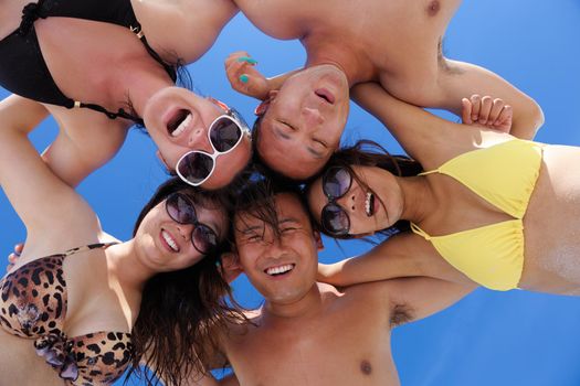 group of happy young people have fun and joy at the  white sand  beach on beautiful summer  day