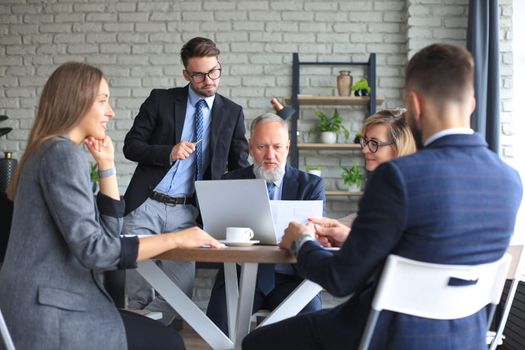 Group of business partners discussing ideas and planning work in office