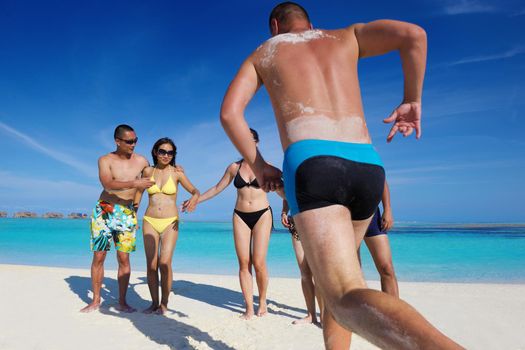 group of happy young people have fun and joy at the  white sand  beach on beautiful summer  day