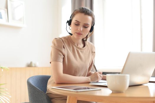 Freelance business women using tablet working call video conference with customer in workplace at home