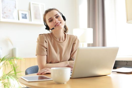 Freelance business women using tablet working call video conference with customer in workplace at home