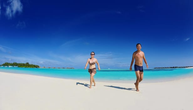 happy young asian couple have fun and romantic time at  summer on beautiful white sand beach