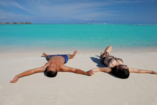 happy young asian couple enjoying summer and have on beautiful white sand beach