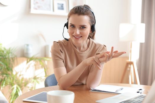 Freelance operator talking with headsets and consulting clients from home office