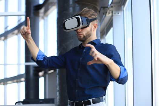 Shot of an engineer wearing a VR headset in an new building. Change the way you see and experience the world