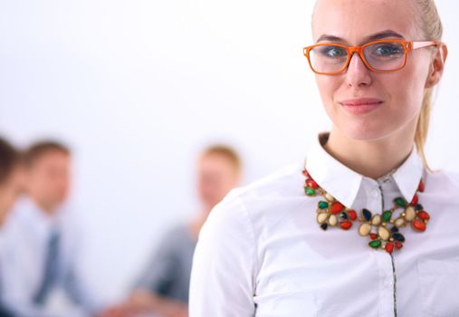 Portrait of a young woman working at office standing .
