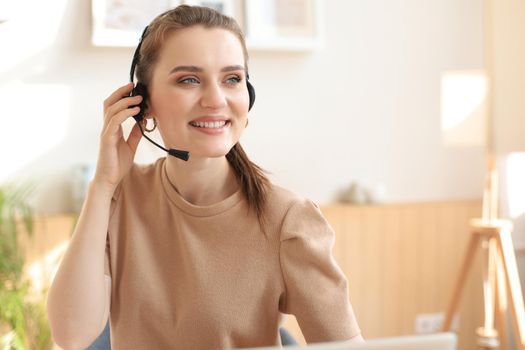 Female customer support operator with headset and smiling