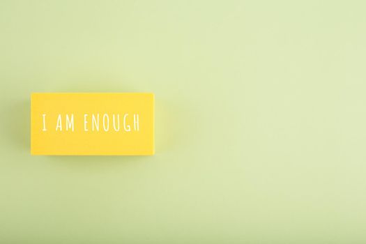 I am enough trendy minimal concept on bright green background. Lettering design, motivation quote, self acceptance and mental health