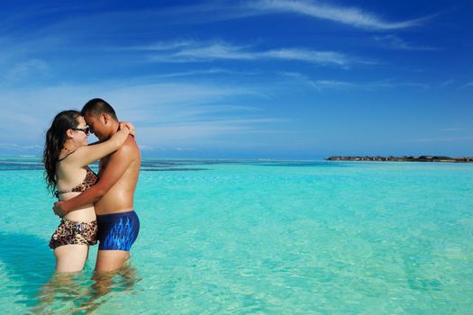 happy young asian couple enjoying summer and have on beautiful white sand beach