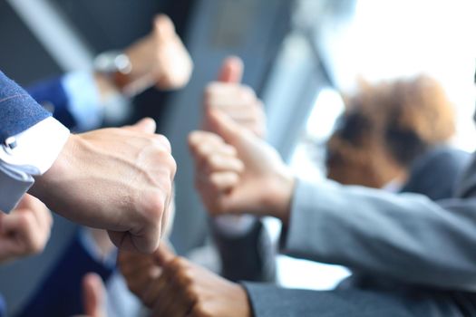 closeup portrait of business people giving thumbs up