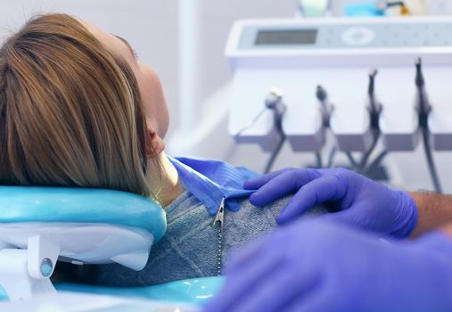 Detail of hand holding dental tools in dental clinic. Dentist Concept.