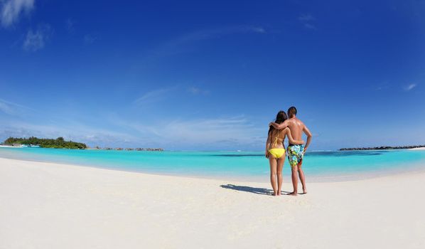 happy young asian couple enjoying summer and have on beautiful white sand beach