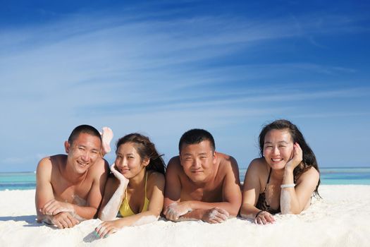 group of happy young people have fun and joy at the  white sand  beach on beautiful summer  day