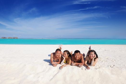 group of happy young people have fun and joy at the  white sand  beach on beautiful summer  day