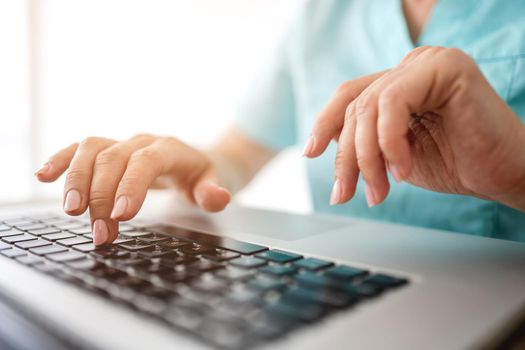 Girl hands typing on laptop keyboard closeup view. Female woman person working with computer