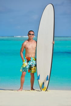 Man with surf board on beautiful tropical beach  beach