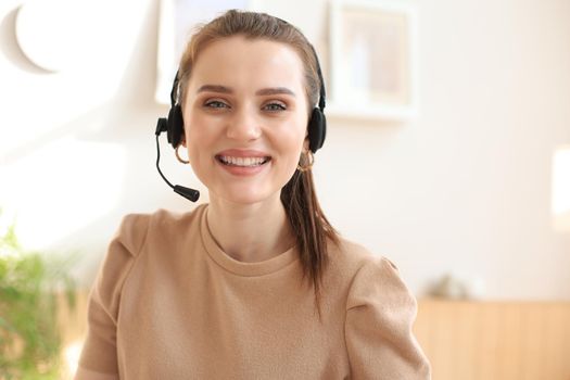Female customer support operator with headset and smiling