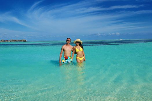 happy young asian couple enjoying summer and have on beautiful white sand beach