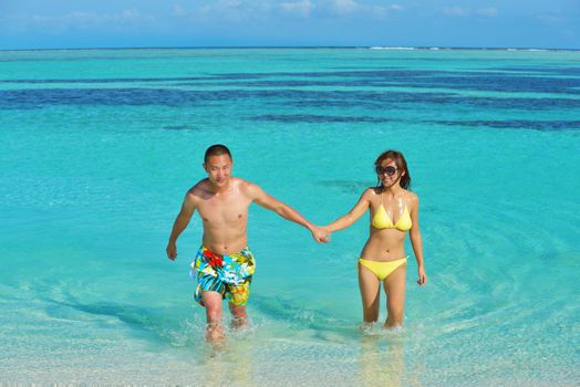 happy young asian couple have fun and romantic time at  summer on beautiful white sand beach