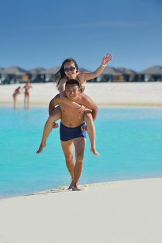 happy young asian couple have fun and romantic time at  summer on beautiful white sand beach