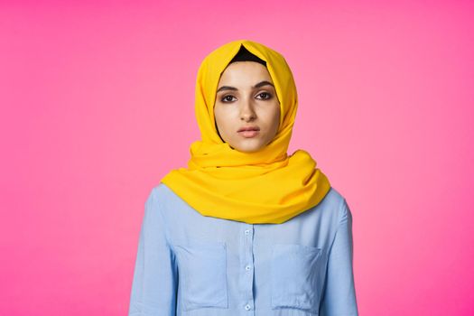 muslim woman in hijab posing fashion ethnicity pink background. High quality photo