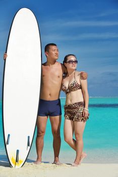 happy young asian couple enjoying summer and have on beautiful white sand beach