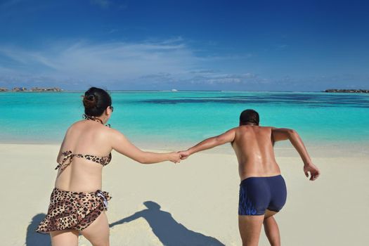 happy young asian couple have fun and romantic time at  summer on beautiful white sand beach