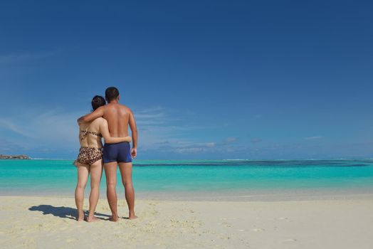 happy young asian couple have fun and romantic time at  summer on beautiful white sand beach