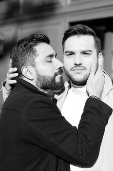 Black and white portrait of young hugging and kissing gays. Concept of love, same sex couple and lgbt.