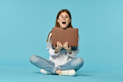 woman sitting on the floor with laptop student education online. High quality photo