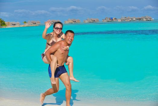 happy young asian couple have fun and romantic time at  summer on beautiful white sand beach