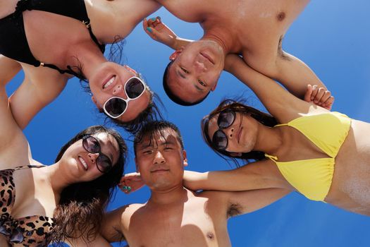 group of happy young people have fun and joy at the  white sand  beach on beautiful summer  day