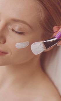 Spa facial mask application. Spa beauty organic facial mask application at day spa salon.