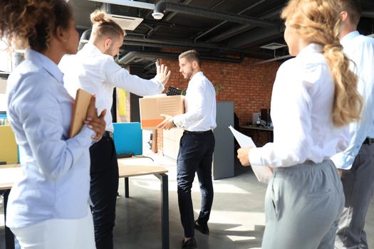 Business colleagues escorting the dismissed employee from office.