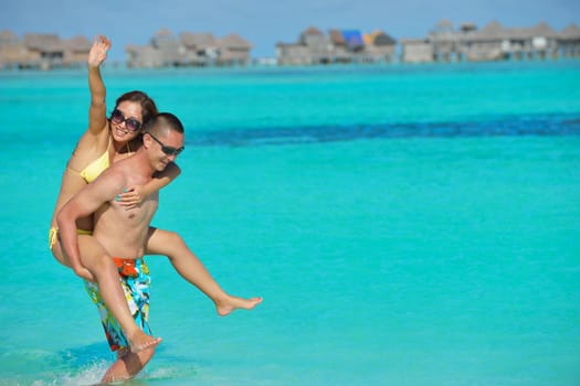 happy young asian couple have fun and romantic time at  summer on beautiful white sand beach