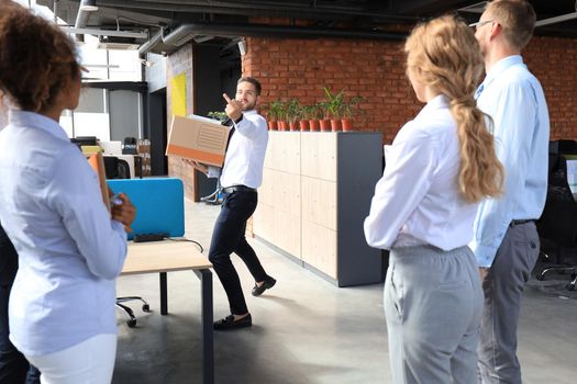 Business colleagues escorting the dismissed employee from office showing fuck.