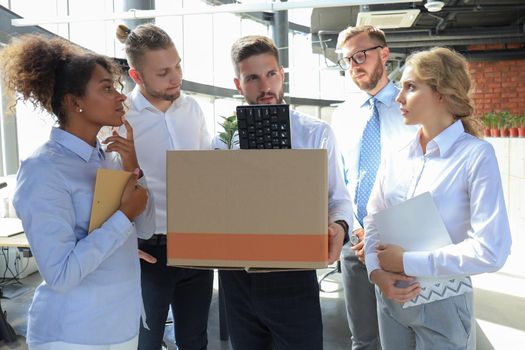 Business colleagues say goodbye to the dismissed employee.